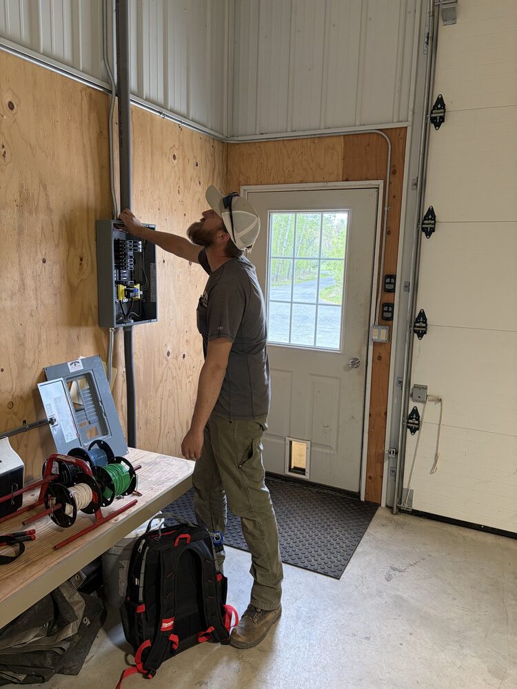 JETA Electric crew member at a panel install in a finished shop