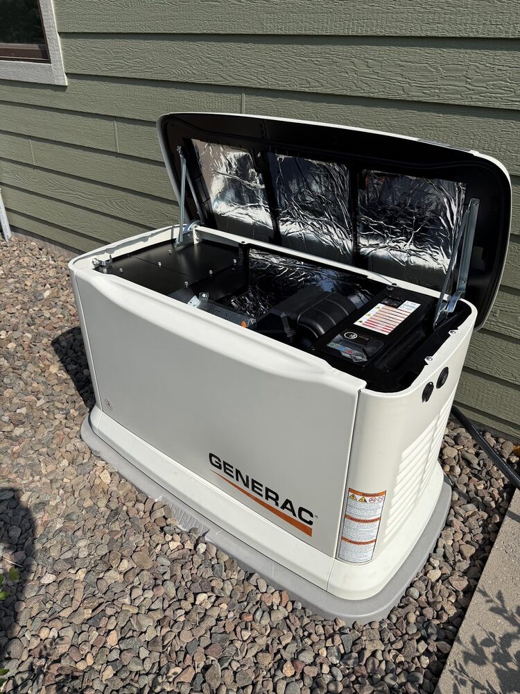 Generac home standby generator opened up showing the engine and controls — serviced by JETA Electric