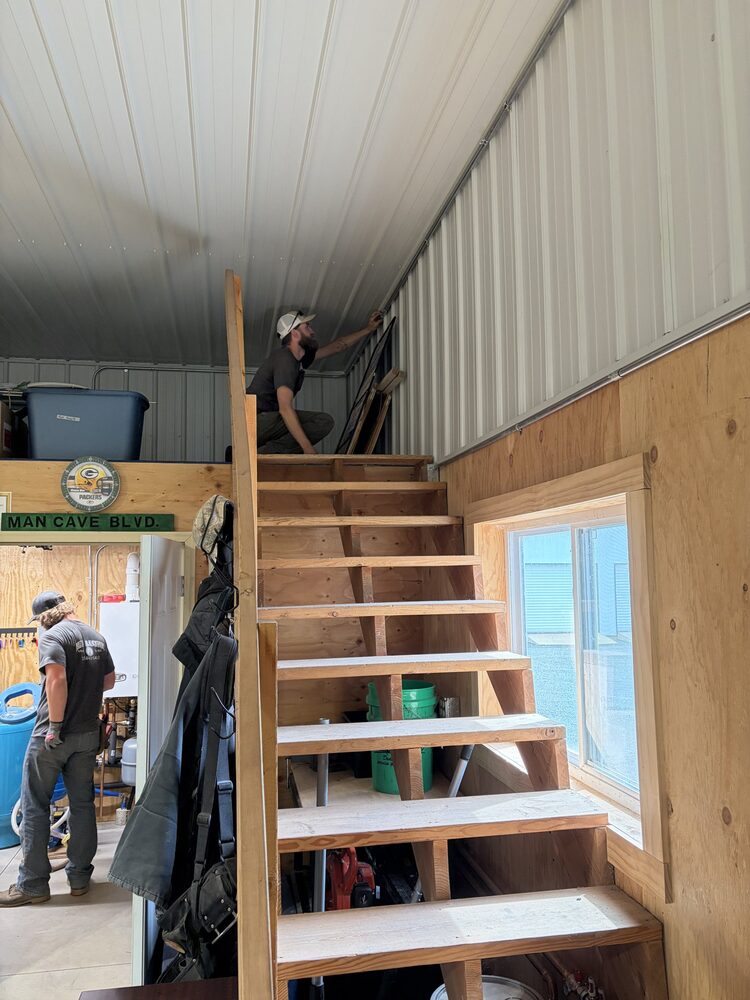 Crew finishing a pole barn loft interior