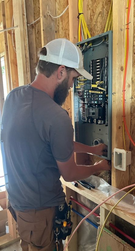 JETA Electric electrician wiring a new panel and load center